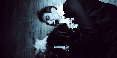 Schauspieler, die als Dracula und junge Frau verkleidet sind